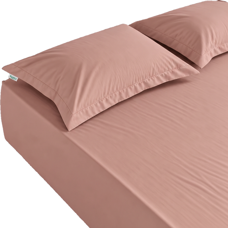 A dusty rose pink bed sheet set including a fitted sheet and two matching pillowcases, shown on a bed against a white background.