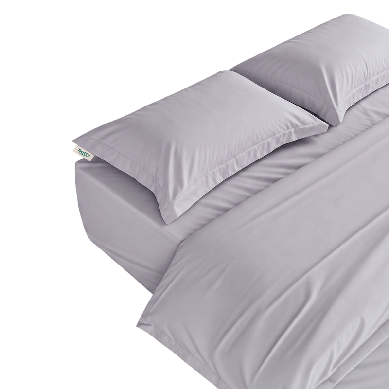 A stack of silver gray bedding, including two pillows and a folded comforter, shown on a plain white background.
